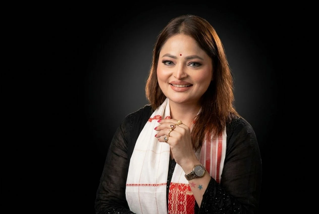 Portrait of Ms. D. Aaliya in a black outfit with a white and red stole