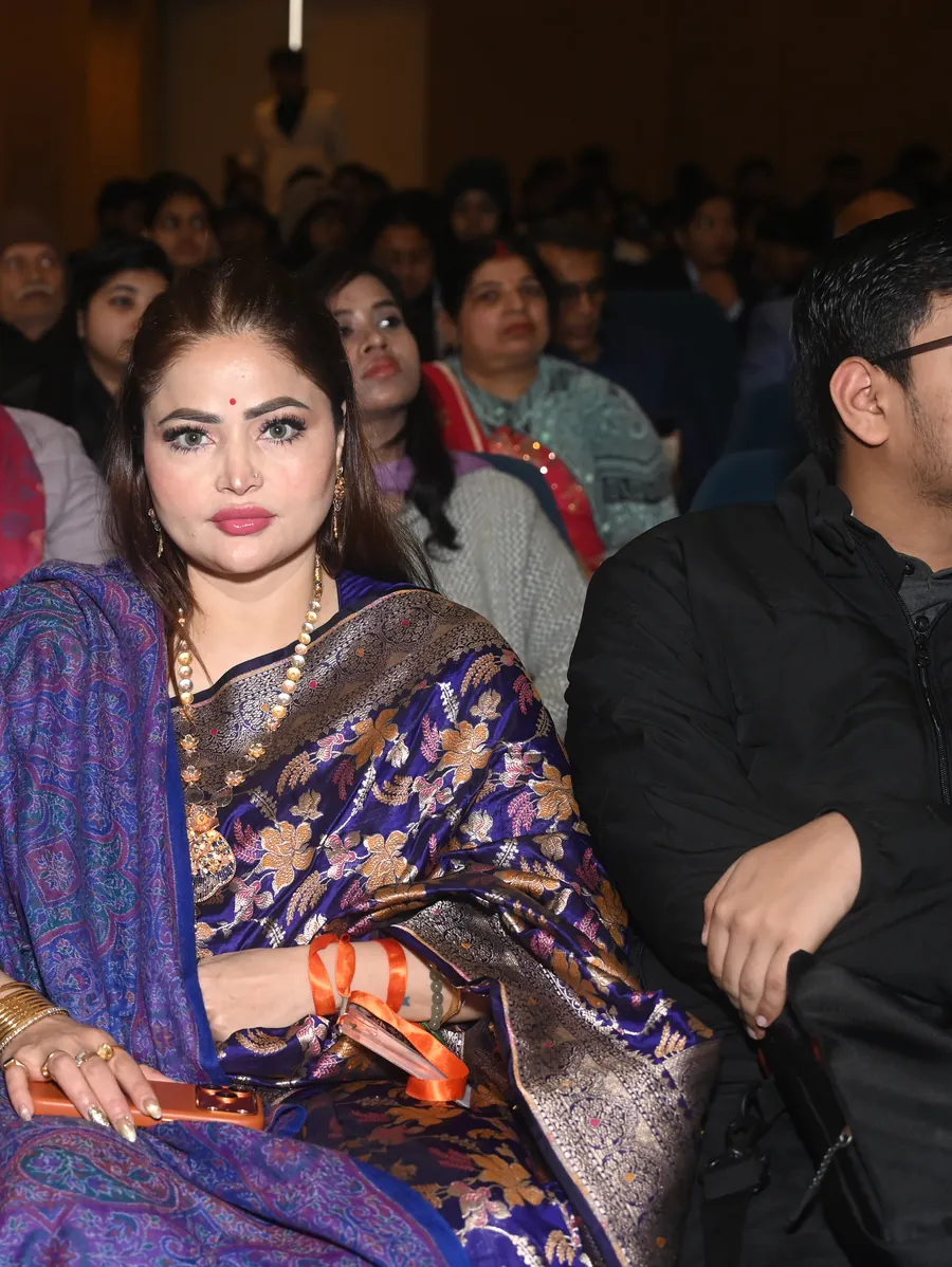 Ms. D. Aaliya in a purple Banarasi saree in the festival audience